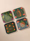 Set of 4 square Dark Academia Scarab Beetle Coasters, featuring detailed Gothic Botanical insect art prints in deep jewel tones. The hardboard coasters have a glossy finish and protective cork base. Premium Entomology Decor.